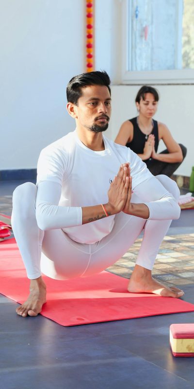 A diverse group of people practicing yoga and meditation indoors with focused concentration.